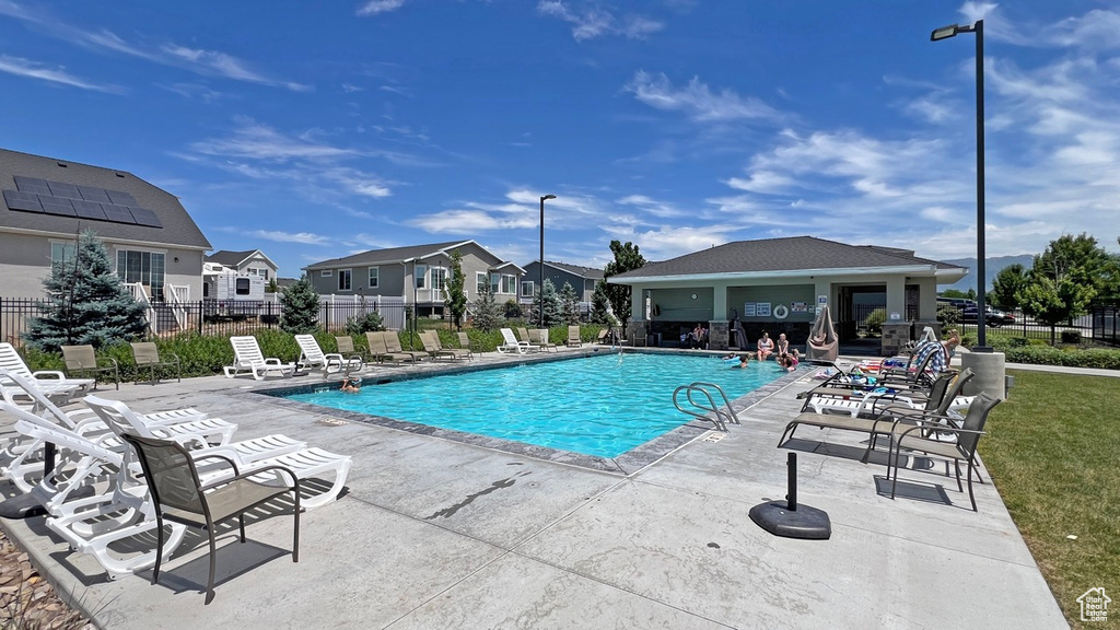 View of pool featuring a patio and a lawn