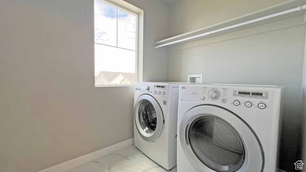 Laundry room with independent washer and dryer, light tile flooring, and hookup for a washing machine