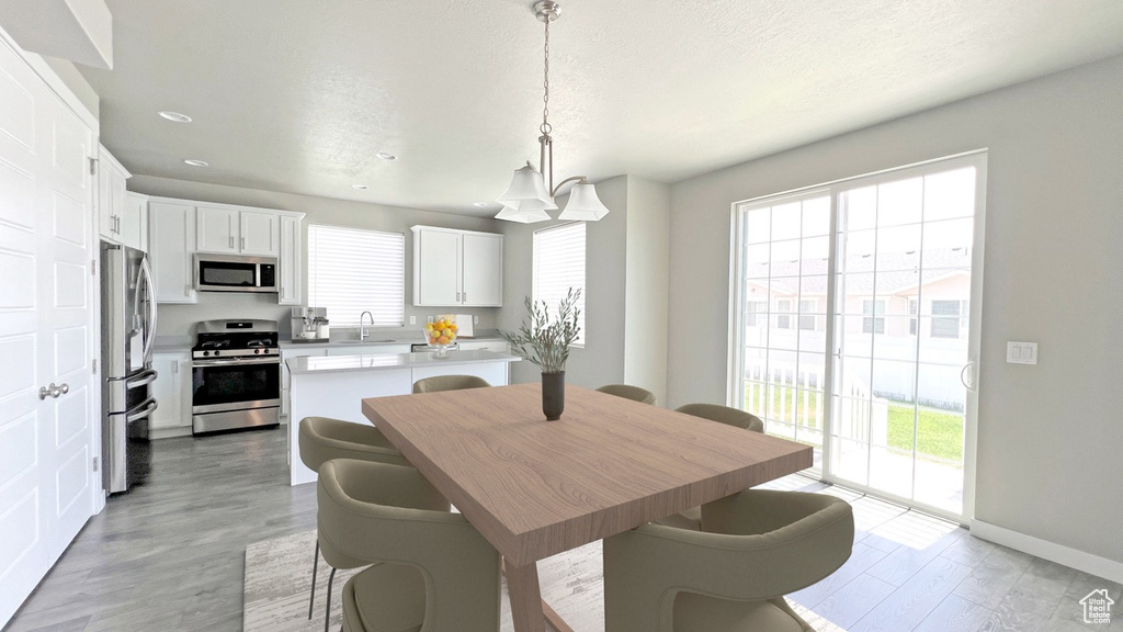 Dining room with light hardwood / wood-style flooring and sink