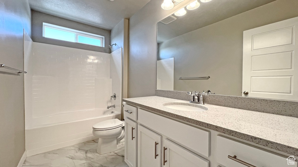 Full bathroom featuring tile flooring, shower / washtub combination, vanity with extensive cabinet space, and toilet