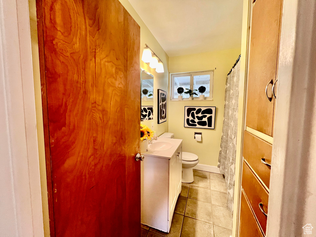 Bathroom with tile patterned flooring, vanity, and toilet