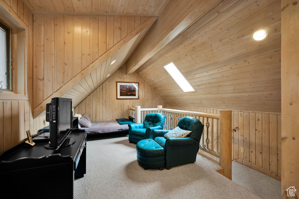 Interior space featuring wood walls, lofted ceiling with skylight, and wood ceiling