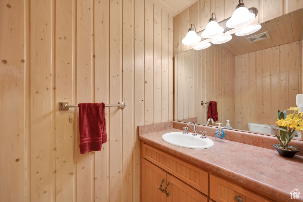 Bathroom featuring oversized vanity and toilet