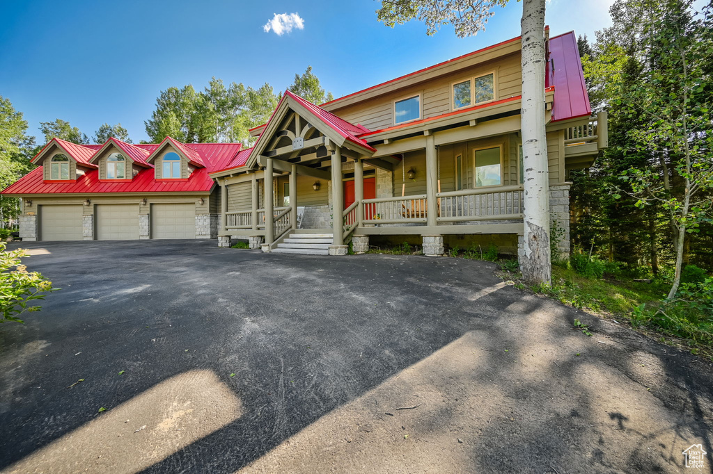 View of front facade with a porch and a garage