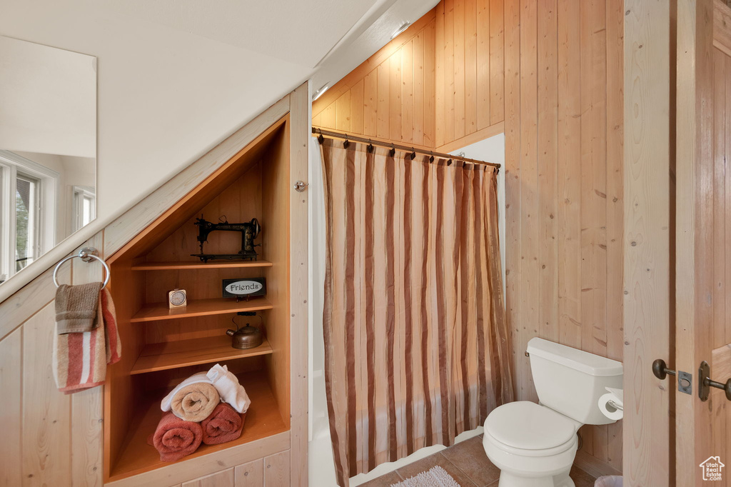 Bathroom with wood walls and toilet