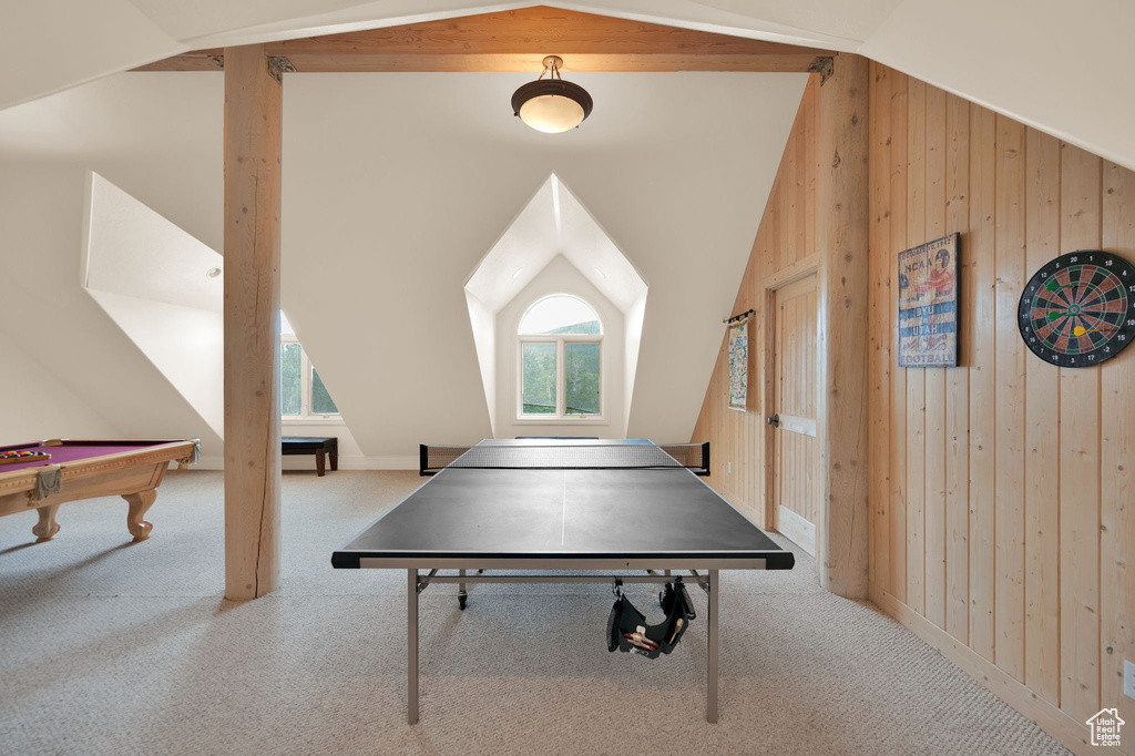 Game room with billiards, vaulted ceiling, carpet floors, and wood walls