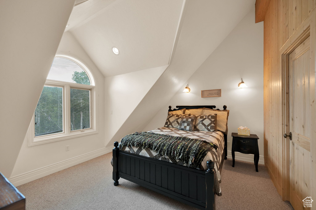 Bedroom featuring vaulted ceiling and carpet flooring