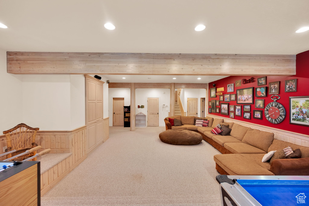 Carpeted living room with beamed ceiling