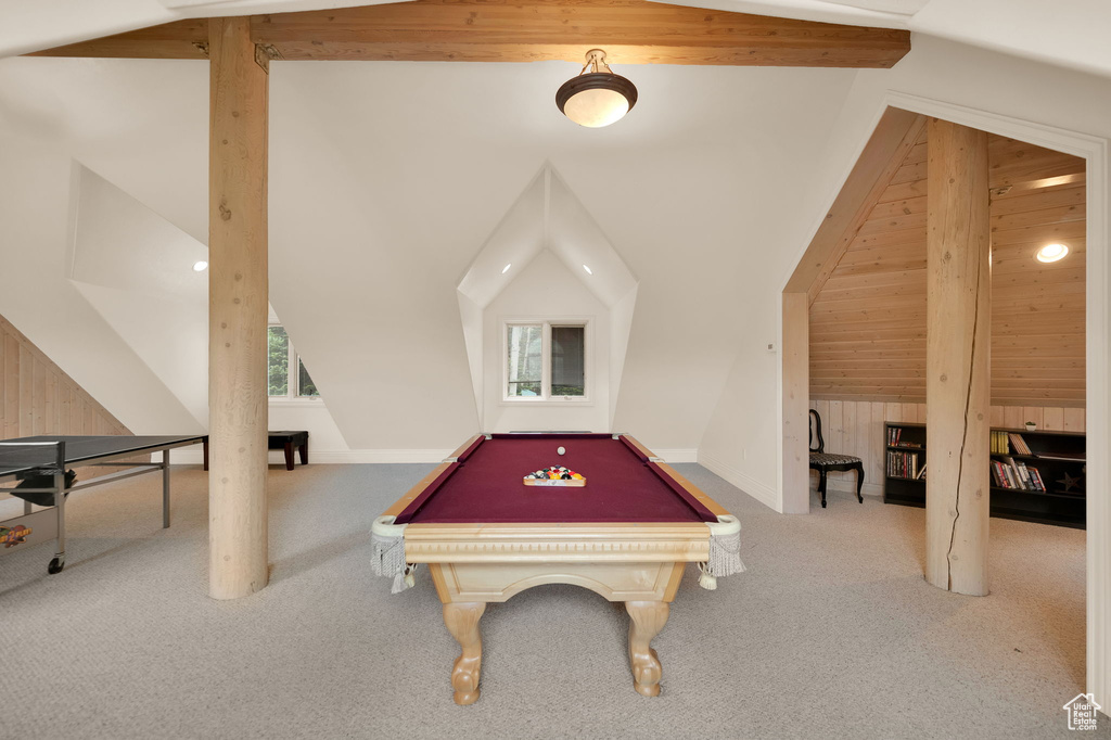 Rec room featuring carpet flooring, lofted ceiling with beams, wooden walls, and billiards