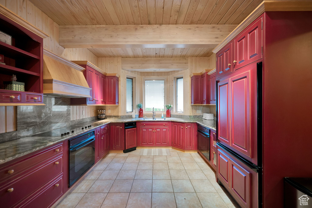 Kitchen with black appliances, wood ceiling, beamed ceiling, sink, and premium range hood