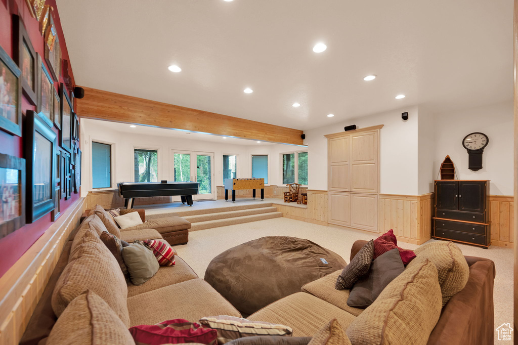 Living room featuring beamed ceiling, light carpet, and billiards