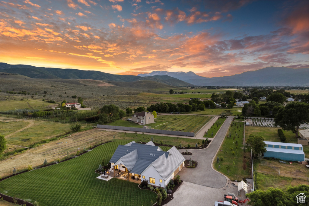 Aerial view at dusk featuring a rural view and a mountain view