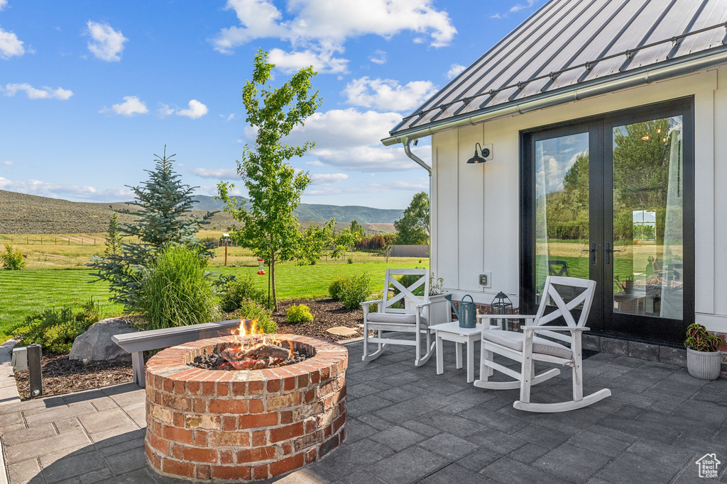 View of patio / terrace with a mountain view and a fire pit