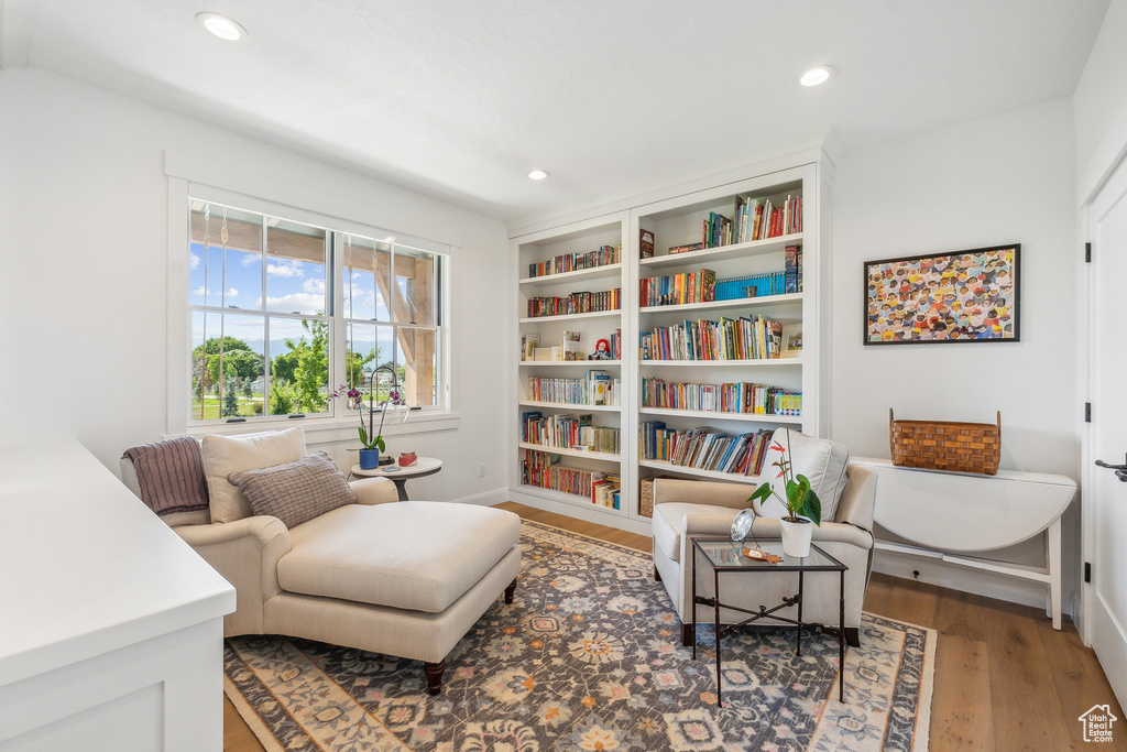 Sitting room featuring wood-type flooring and built in features