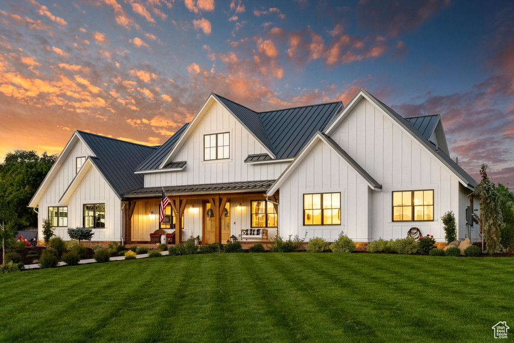 Back house at dusk with a yard