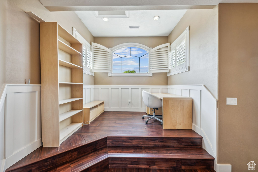 Office area with dark hardwood / wood-style floors