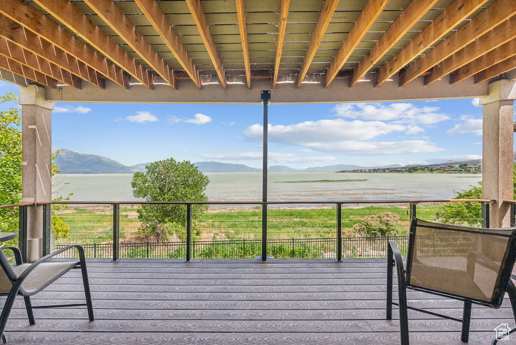 Deck with a water and mountain view