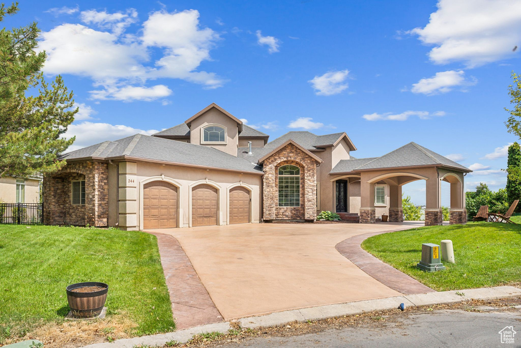 View of front facade with a garage and a front lawn