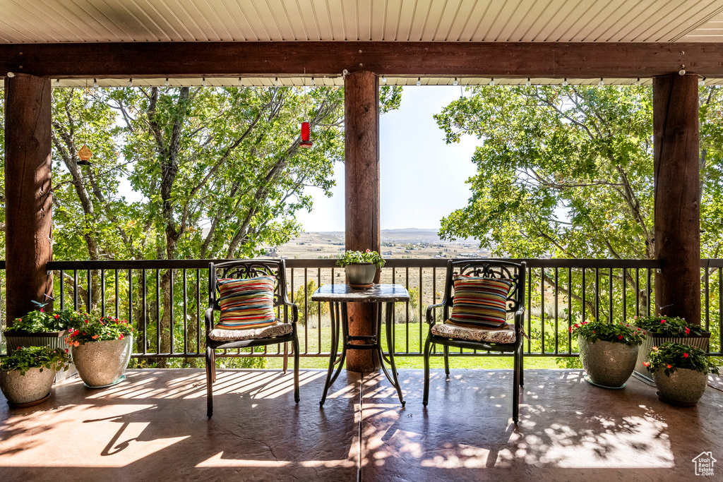 Unfurnished sunroom with beam ceiling and wooden ceiling