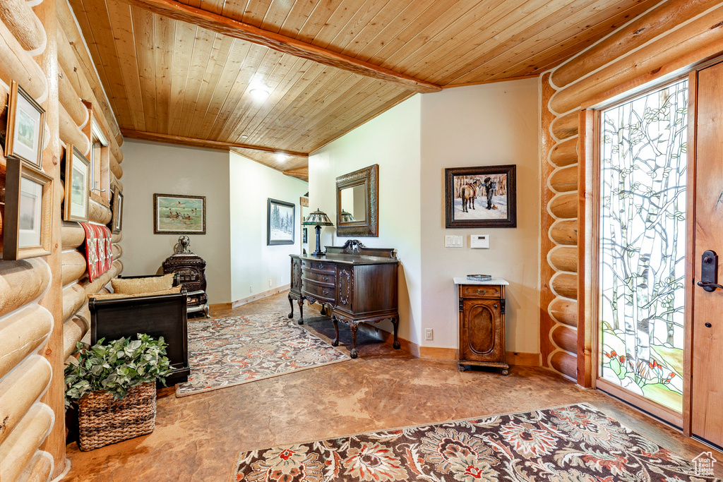 Office area with rustic walls and wood ceiling