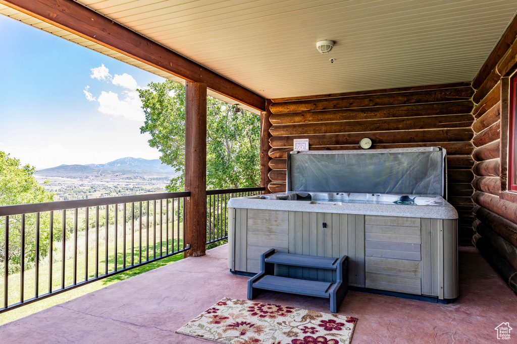 View of terrace featuring a mountain view and a hot tub