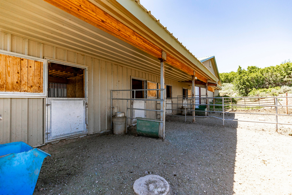 View of horse barn with an outdoor structure