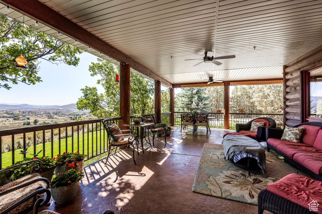 View of patio featuring an outdoor living space, ceiling fan, and a mountain view