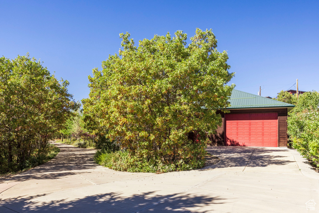 Obstructed view of property with an outbuilding and a garage