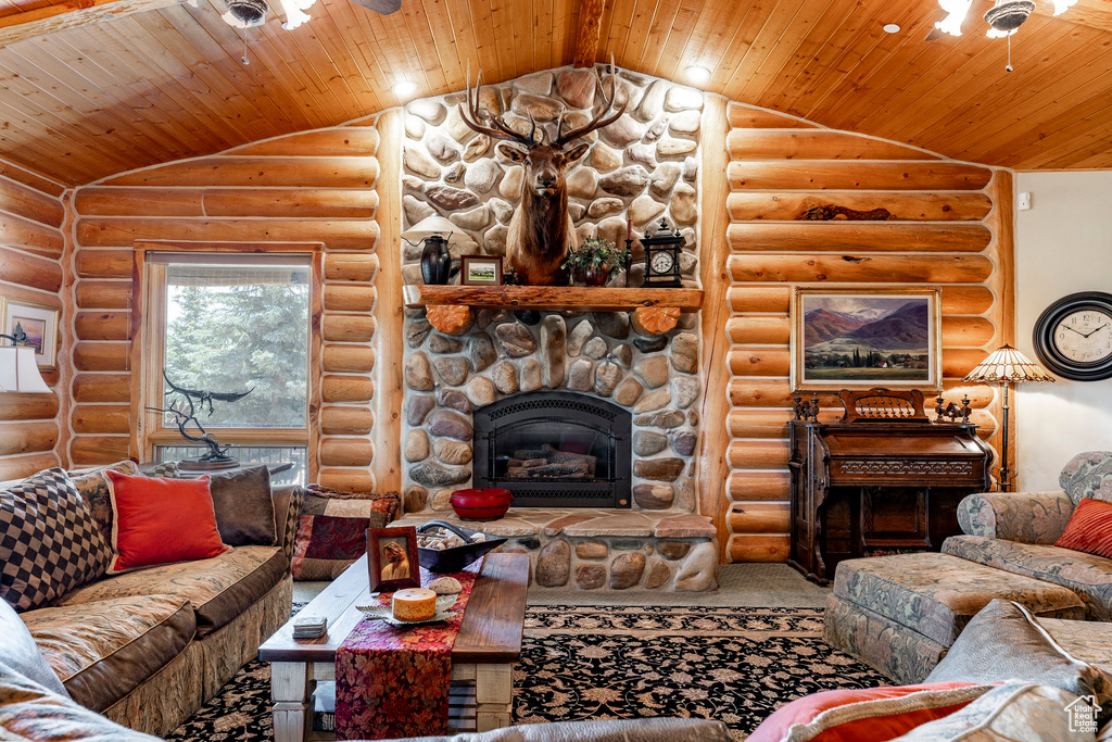 Living room featuring wood ceiling, log walls, and lofted ceiling