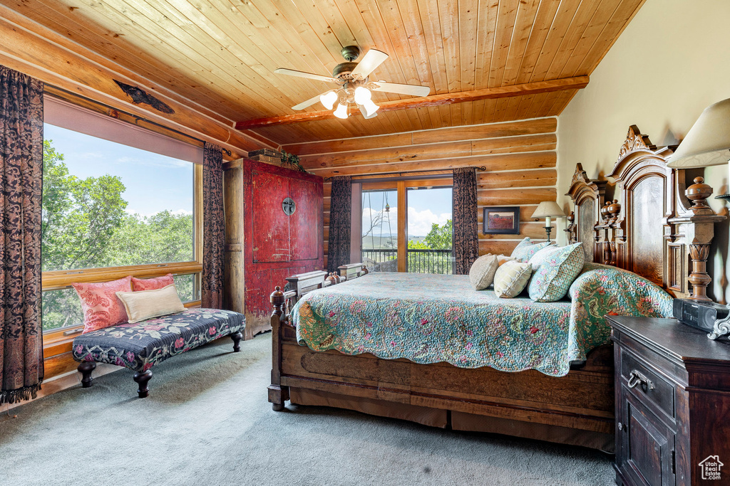 Carpeted bedroom featuring rustic walls, ceiling fan, wood ceiling, and multiple windows