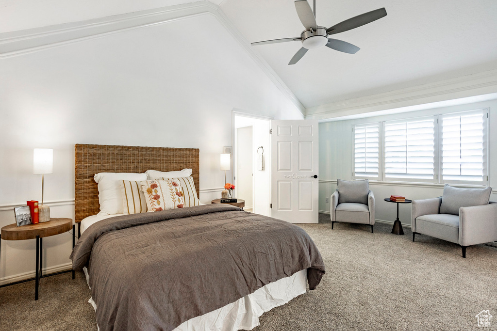 Carpeted bedroom with crown molding, ceiling fan, and vaulted ceiling