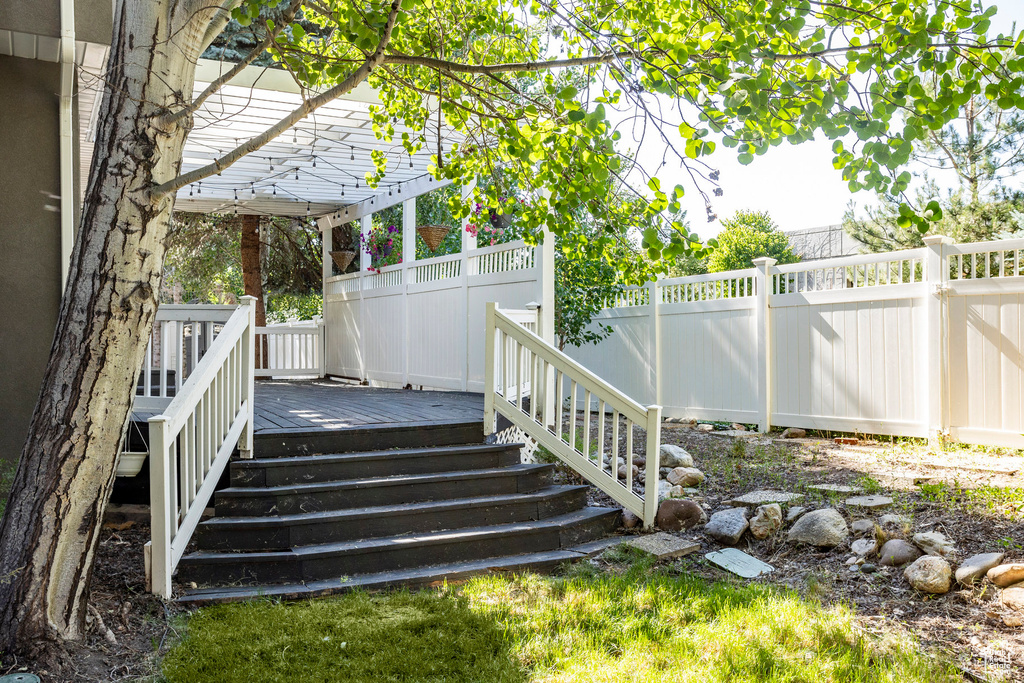 View of yard featuring a pergola and a wooden deck