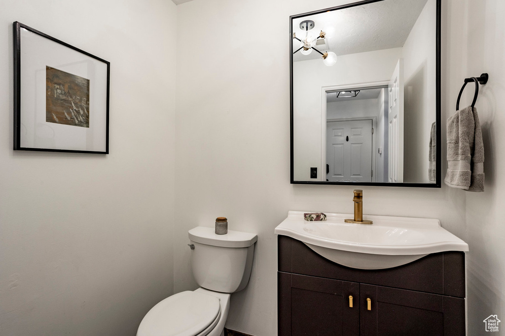 Bathroom featuring toilet and large vanity