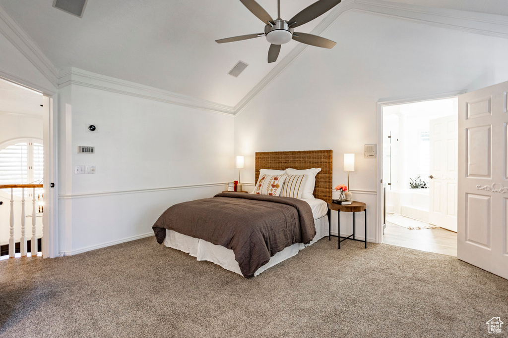 Bedroom featuring ceiling fan, crown molding, high vaulted ceiling, connected bathroom, and carpet floors