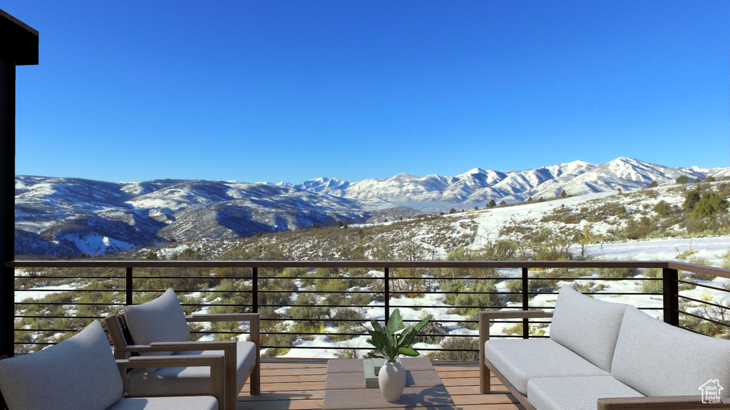 Snow covered back of property featuring a mountain view