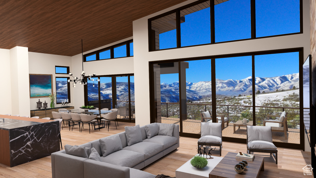 Living room featuring light wood finished floors, wood ceiling, high vaulted ceiling, an inviting chandelier, and a mountain view