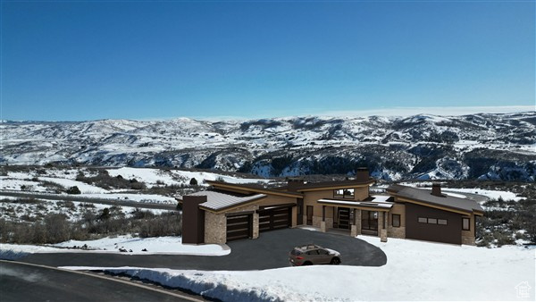 Exterior space featuring aphalt driveway and a mountain view