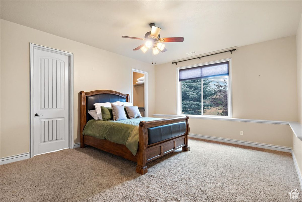 Carpeted bedroom with ceiling fan