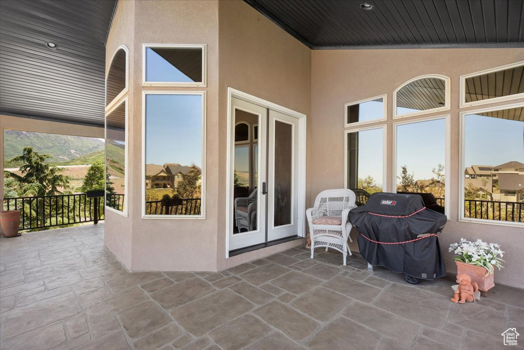 View of terrace with a mountain view and grilling area