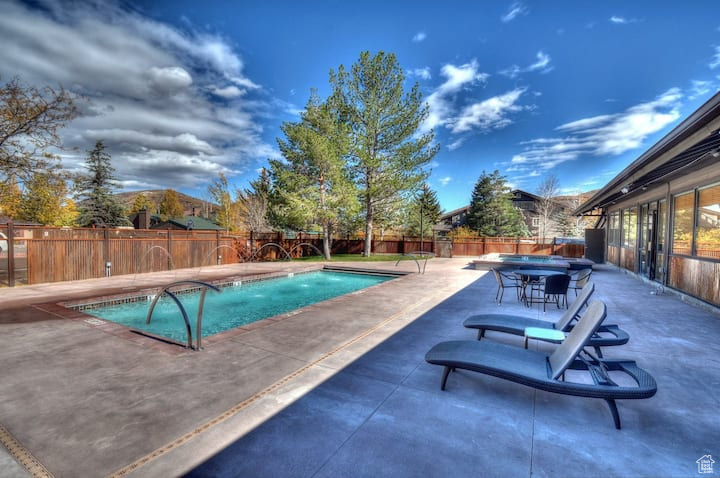 View of swimming pool with a patio and pool water feature