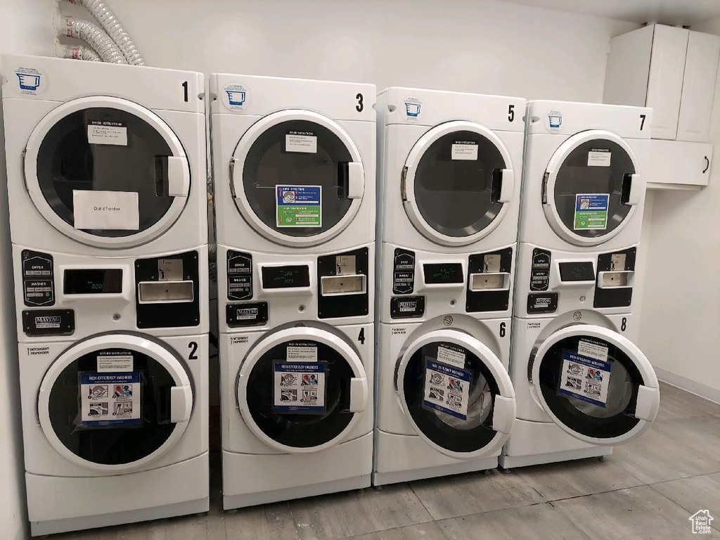 Laundry room featuring stacked washer and clothes dryer and washing machine and clothes dryer