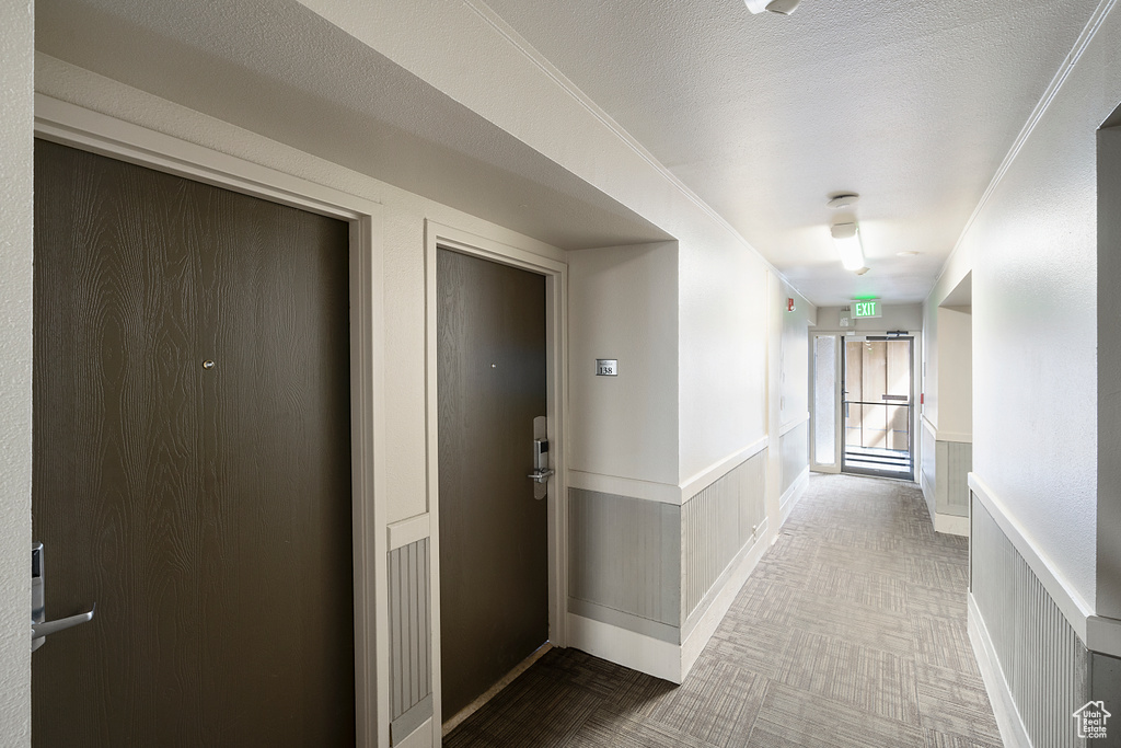 Corridor featuring a textured ceiling