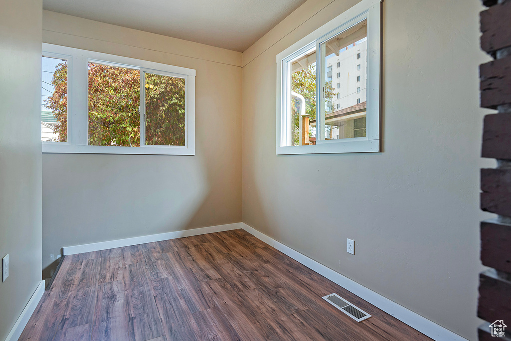 Spare room featuring wood-type flooring