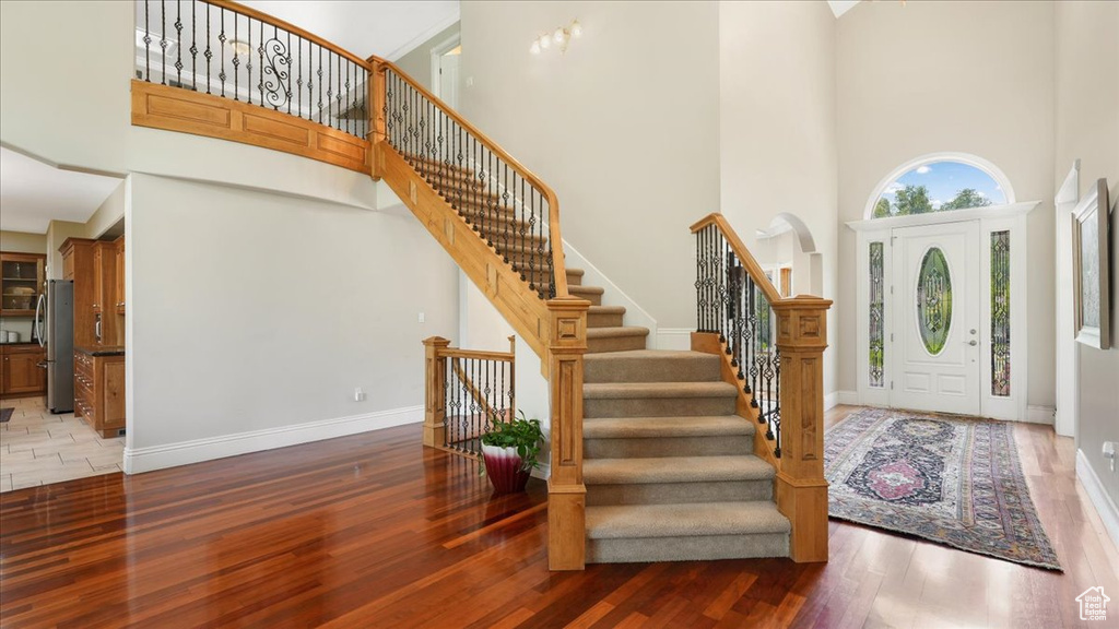 Foyer entrance featuring a high ceiling and hardwood / wood-style flooring