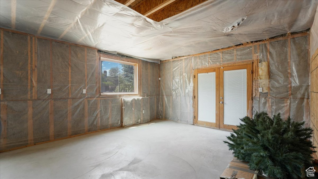 Spare room featuring concrete floors and french doors