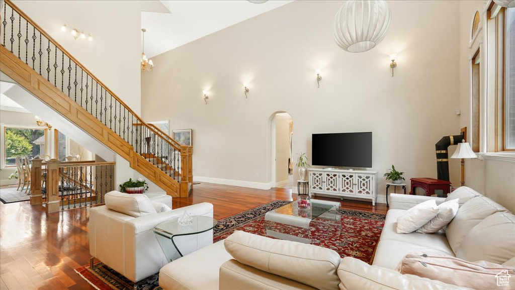 Living room featuring a high ceiling and wood-type flooring