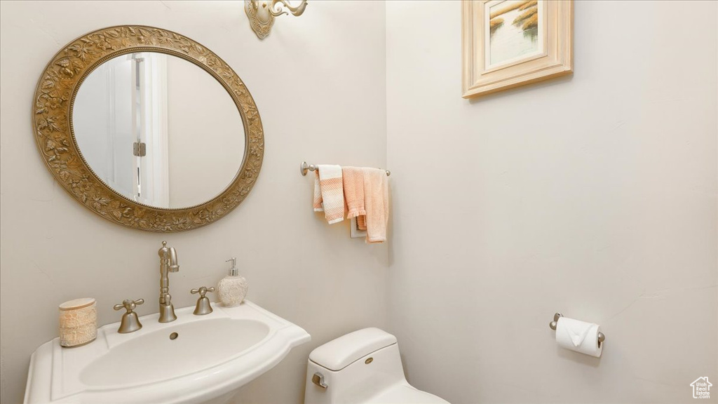 Bathroom featuring sink and toilet