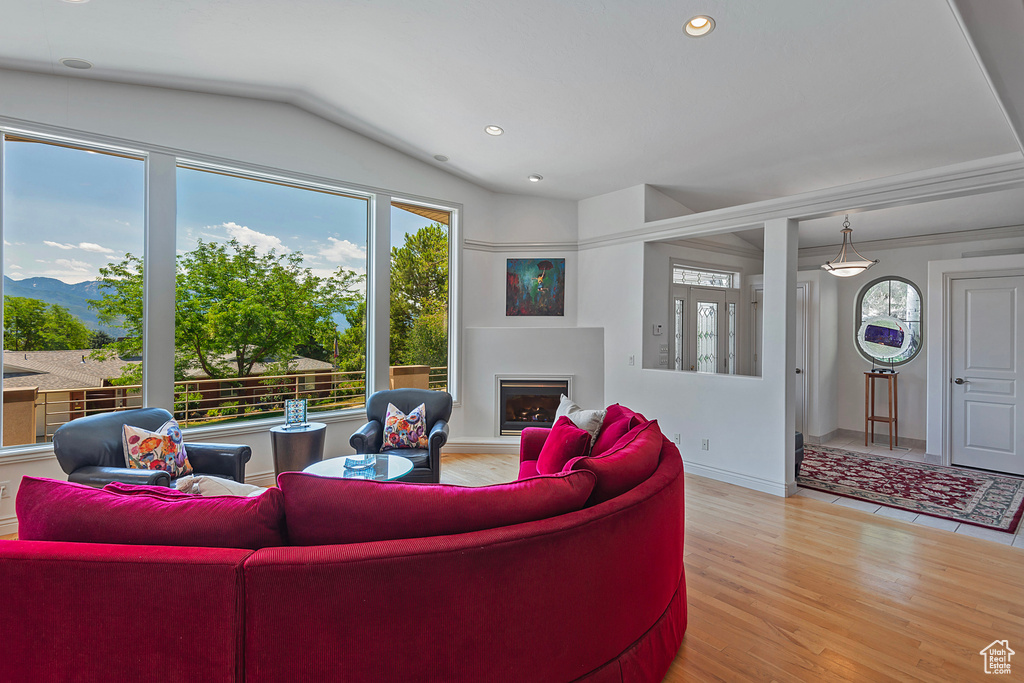 Living room featuring hardwood / wood-style flooring and lofted ceiling