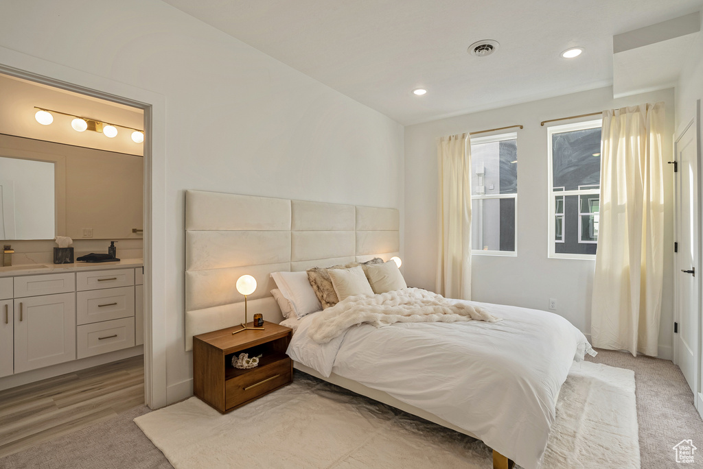 Bedroom featuring light hardwood / wood-style floors and sink