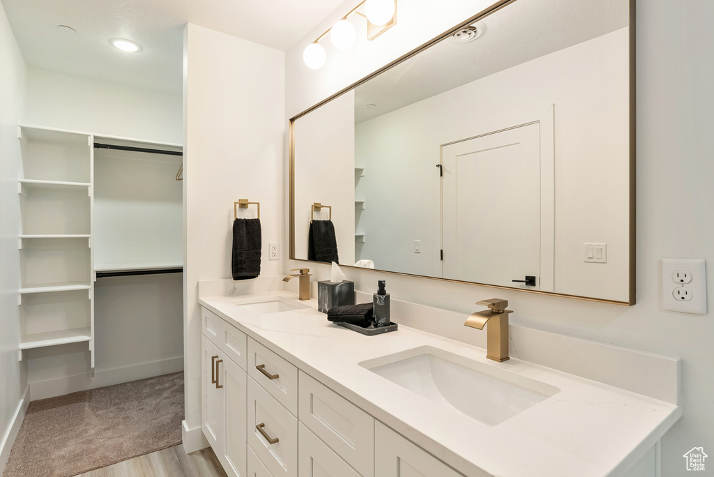 Bathroom featuring vanity and hardwood / wood-style floors